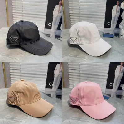 Four baseball caps in a two by two grid, black, cream, tan and pink, each photographed in front of a window blind