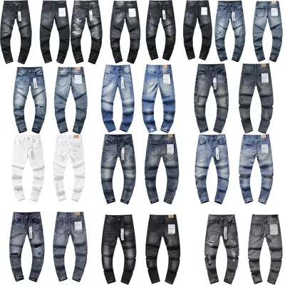 Twenty pairs of jeans laid flat in rows, in light, mid and dark washes with distressing on several