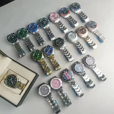 About twenty steel-bracelet wristwatches laid out on a cloth, dials in green, blue, black, white and pink, with one more in an open box